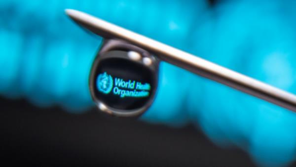 World Health Organization logo is reflected in a drop on a syringe needle in this illustration photo taken March 16, 2021. REUTERS/Dado Ruvic/Illustration//File Photo



