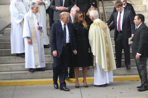 Trump and Melania spoke to one of the priests after the funeral.