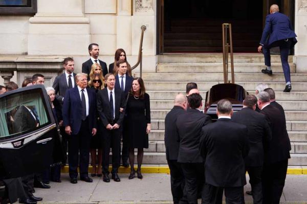 Do<em></em>nald Trump and his family look on while pall bearers bring his sister's casket into the church.